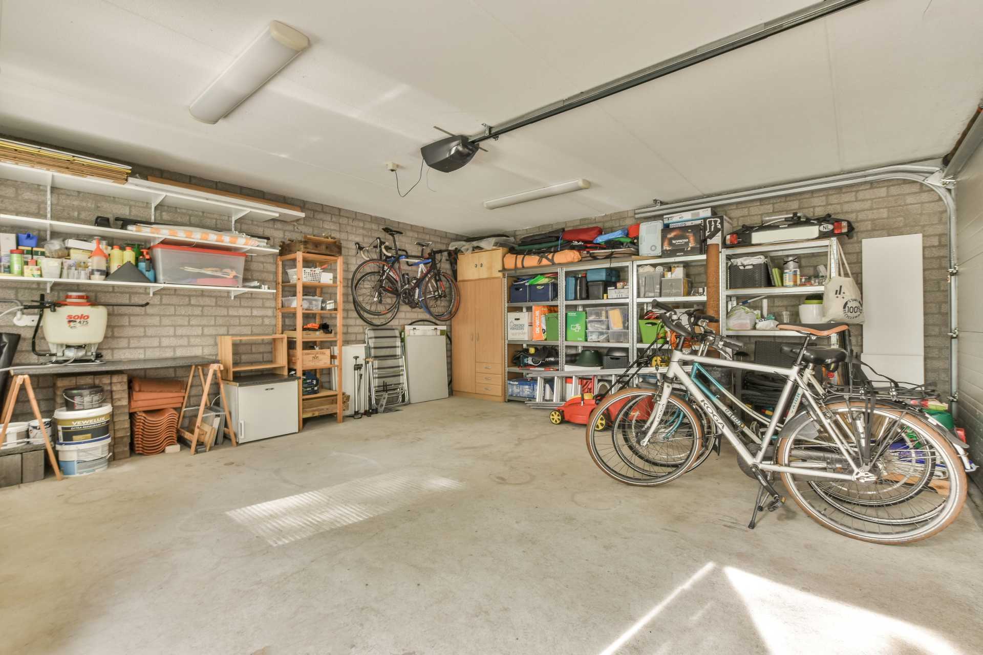 a garage with bikes and shelves and a brick wall