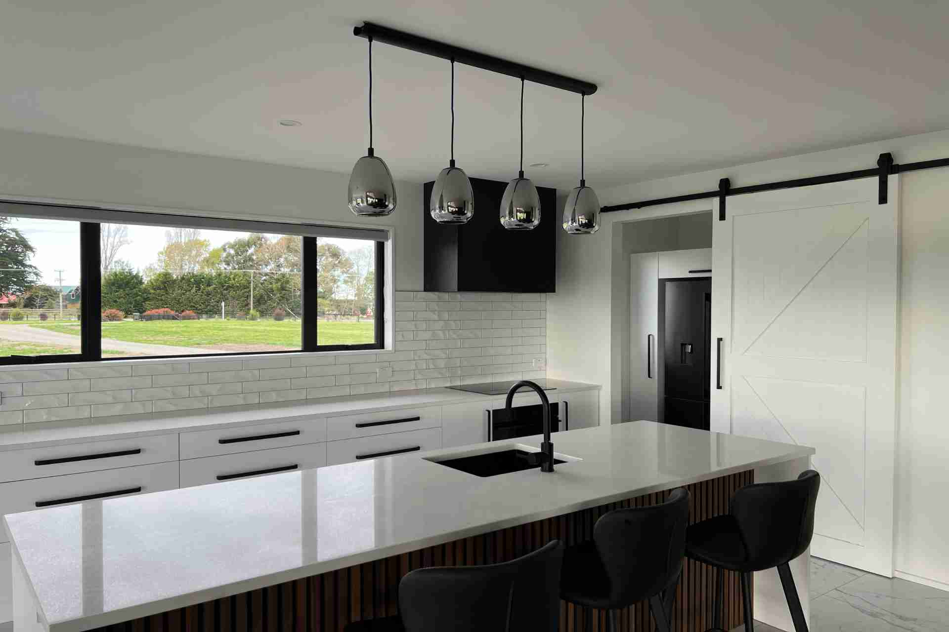bright modern kitchen with island and countryside views