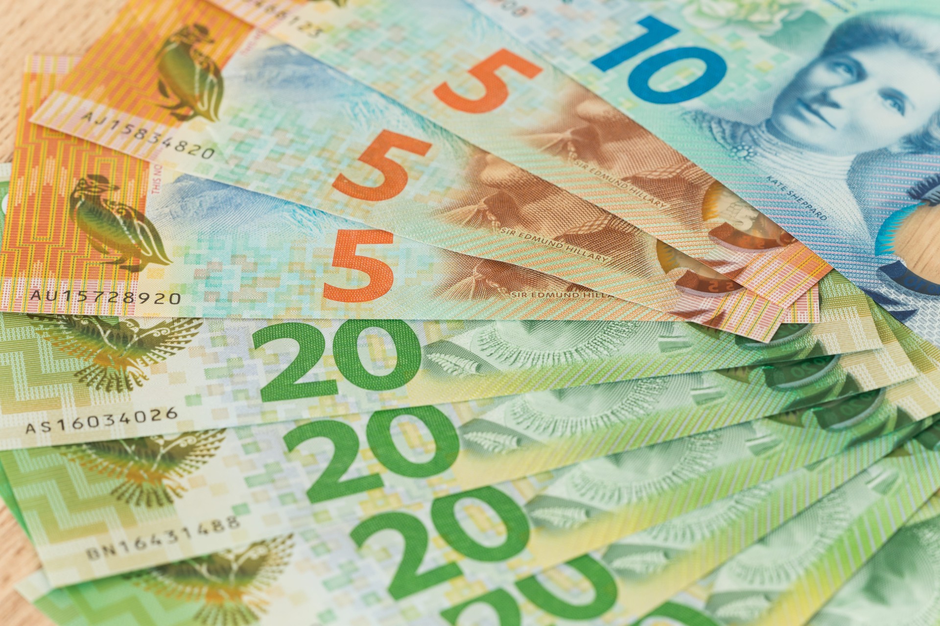 A spread of colorful Australian banknotes, including $5, $10, and $20 bills arranged in a fan.