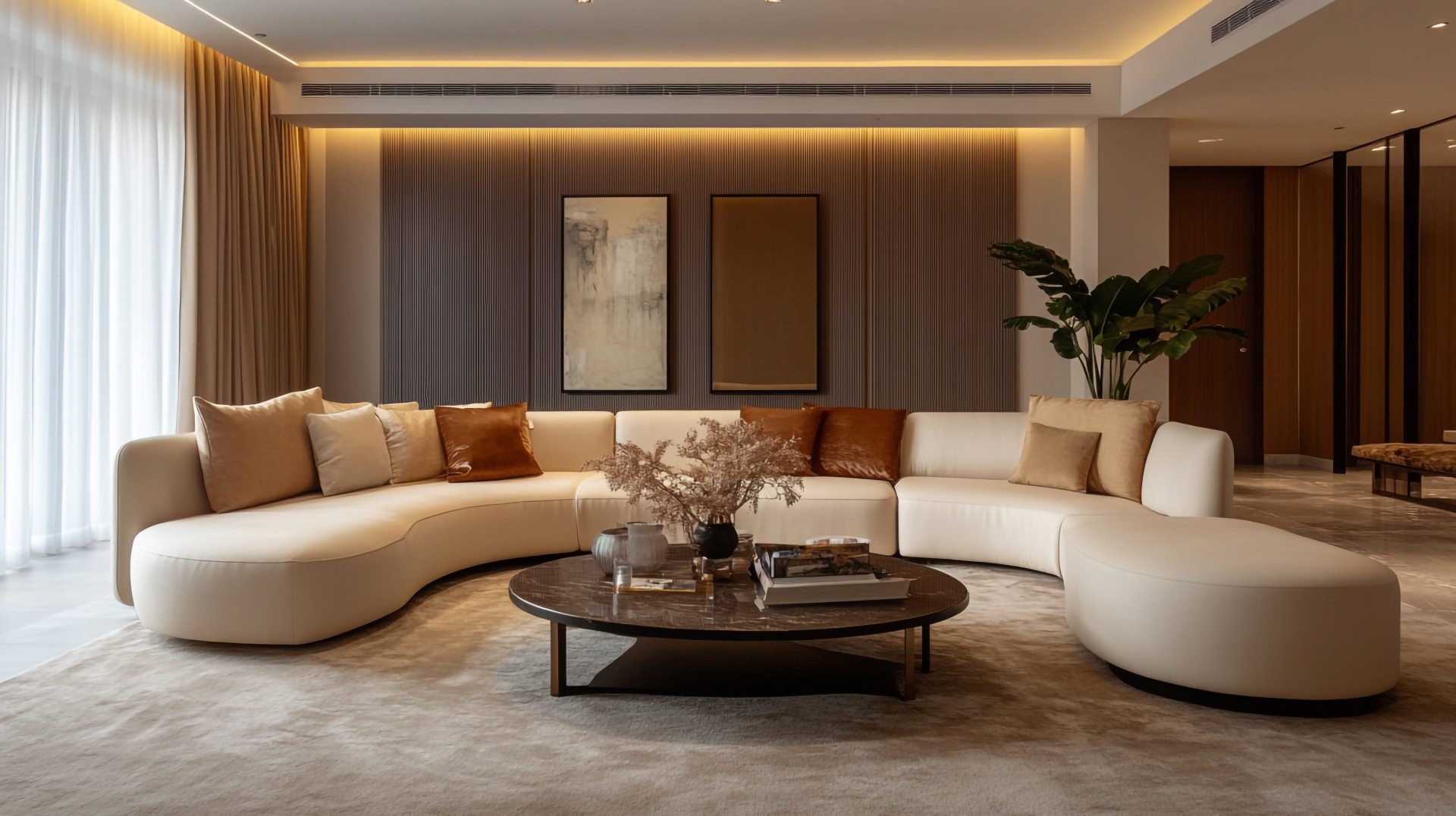 Modern living room with curved sectional sofa, warm lighting, neutral tones, and minimalist decor