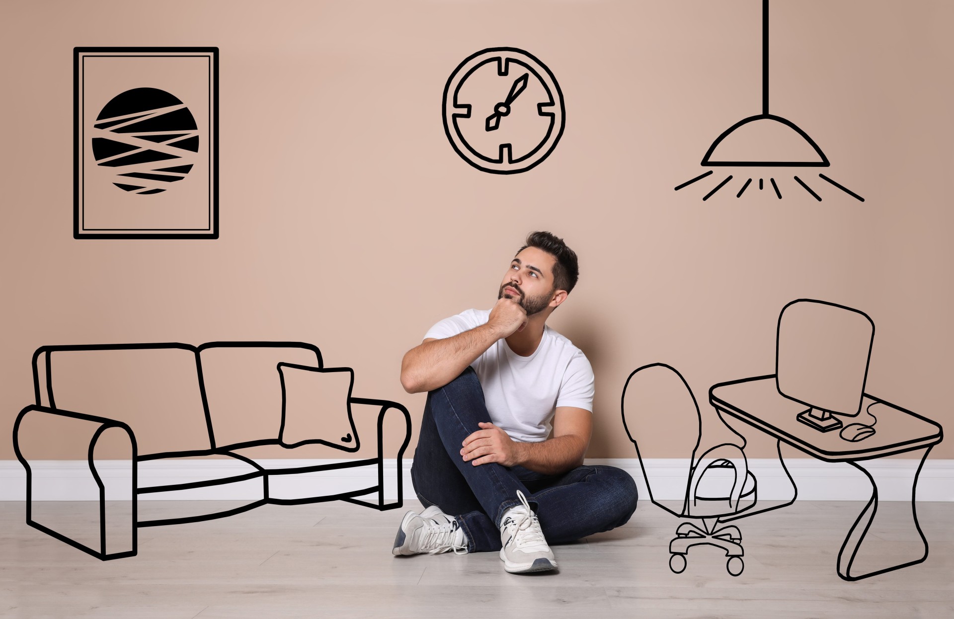 A man sitting on the floor looking up thoughtfully, surrounded by simple line drawings of a couch, desk, chair, clock, and lamp on a wall
