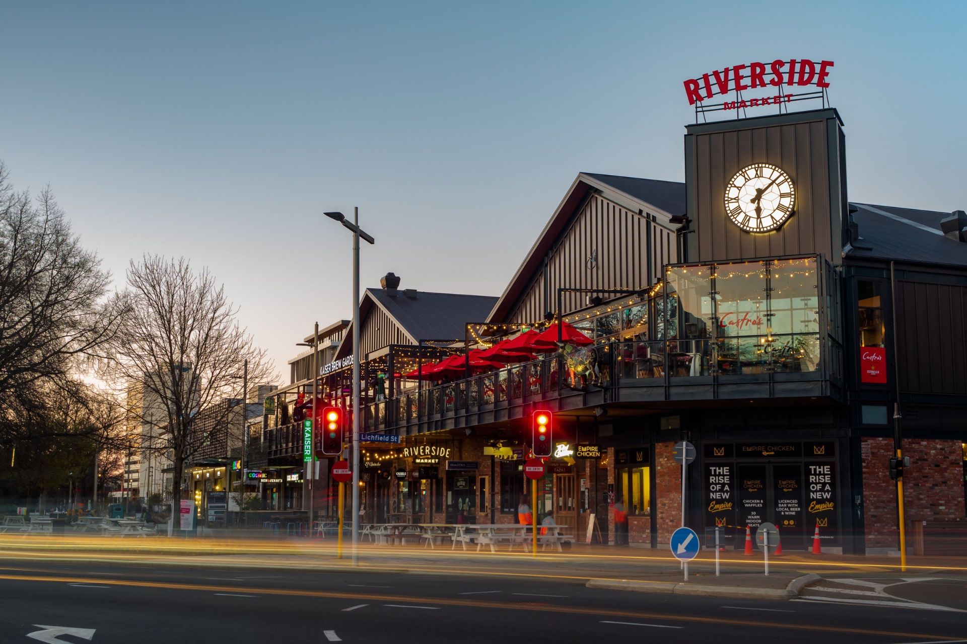 Christchurch Riverside Market surrounded by city buildings at dusk.