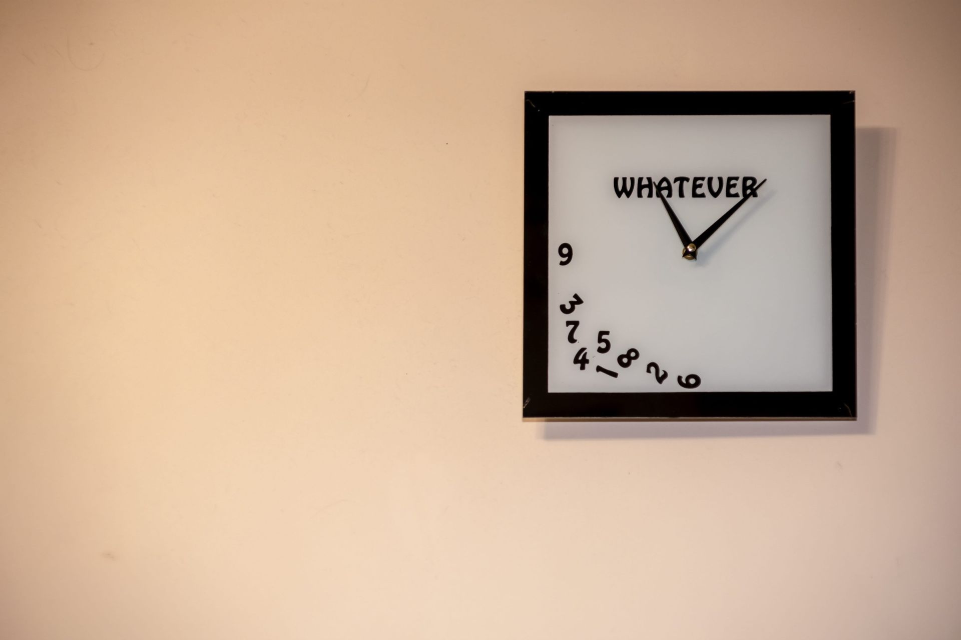 Cool, minimalist wall clock displayed against a neutral wall.