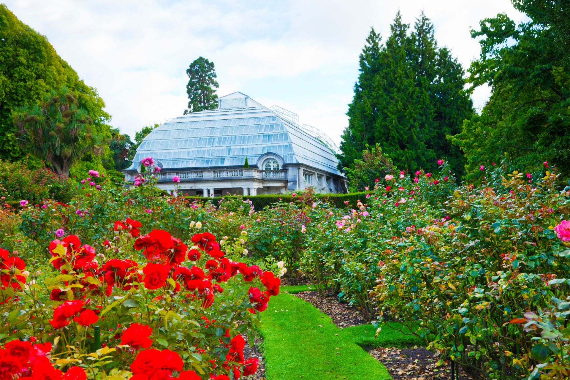 Christchurch Botanic Gardens with landscaped flower beds and a glasshouse